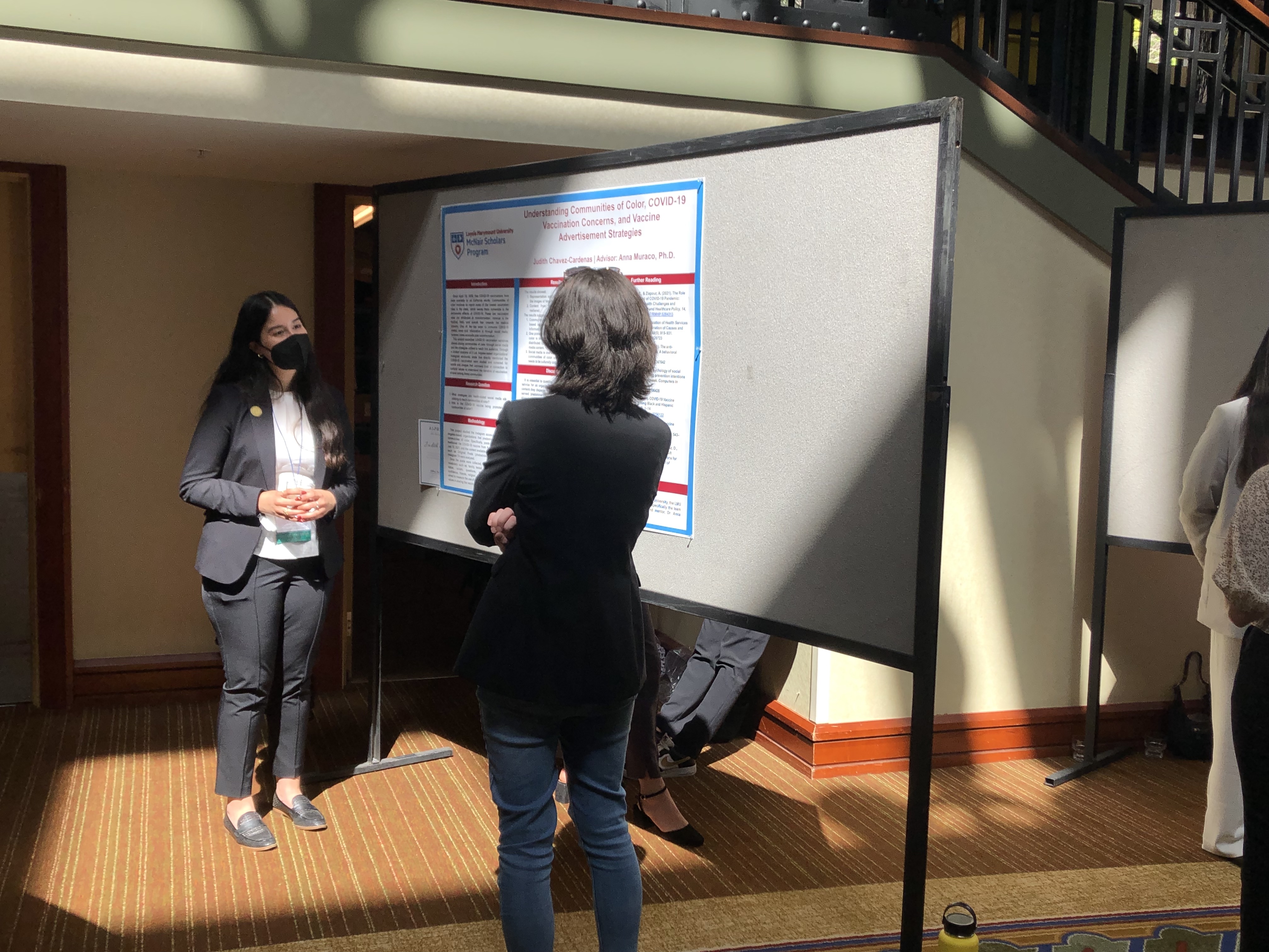Student presenting research poster at undergraduate conference